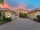 Attractive home with courtyard garage doors, brick drive and well-maintained landscaping at 12448 Highfield Cir, Lakewood Ranch, FL 34202