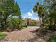 A charming residence boasts a paver driveway, lush landscaping, and an inviting entrance with a well-manicured garden at 12448 Highfield Cir, Lakewood Ranch, FL 34202
