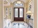 Grand foyer featuring a decorative glass front door, stone columns, and tiled flooring at 12448 Highfield Cir, Lakewood Ranch, FL 34202