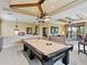 Spacious game room with a pool table, decorative lighting, and a cozy seating area at 12448 Highfield Cir, Lakewood Ranch, FL 34202