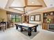 A game room featuring coffered ceilings, a pool table and bar area with shelves at 12448 Highfield Cir, Lakewood Ranch, FL 34202