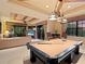 Relaxing game room showcasing the pool table and living area, with doors to the outdoor deck at 12448 Highfield Cir, Lakewood Ranch, FL 34202