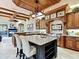 Gourmet kitchen featuring custom wood cabinets, granite counters, and a large center island with seating at 12448 Highfield Cir, Lakewood Ranch, FL 34202