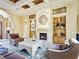 Cozy living room featuring fireplace, coffered ceiling, and built-in shelving at 12448 Highfield Cir, Lakewood Ranch, FL 34202