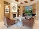 Comfortable living room with fireplace, coffered ceiling, and view of backyard at 12448 Highfield Cir, Lakewood Ranch, FL 34202