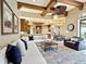 Open concept living room with exposed wood beams and access to the kitchen at 12448 Highfield Cir, Lakewood Ranch, FL 34202