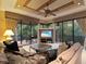 Living room showing comfortable seating with balcony access and a view of the lush outdoors at 12448 Highfield Cir, Lakewood Ranch, FL 34202