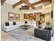Bright living room showcasing exposed beams, a ceiling fan, and open access to the kitchen at 12448 Highfield Cir, Lakewood Ranch, FL 34202