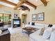 Comfortable living room featuring high ceilings, exposed beams, and an entertainment center at 12448 Highfield Cir, Lakewood Ranch, FL 34202