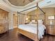 A main bedroom suite with a canopy bed, hardwood flooring, and comfortable furnishings at 12448 Highfield Cir, Lakewood Ranch, FL 34202