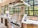 Gourmet outdoor grill with countertop and tiled backsplash, perfect for entertaining and enjoying outdoor cooking at 12448 Highfield Cir, Lakewood Ranch, FL 34202