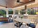 Outdoor kitchen featuring a fireplace, dining area, TV and built-in grill at 12448 Highfield Cir, Lakewood Ranch, FL 34202