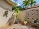 Private outdoor shower area with brick pavers, wall fountain feature, and lush tropical plants at 12448 Highfield Cir, Lakewood Ranch, FL 34202