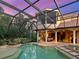 Backyard with screened in pool, outdoor kitchen and covered patio at 12448 Highfield Cir, Lakewood Ranch, FL 34202