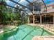 Inviting pool area surrounded by lush tropical landscaping and a screened enclosure for ultimate relaxation at 12448 Highfield Cir, Lakewood Ranch, FL 34202