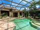 Resort-style pool area with an attached spa and screened enclosure, enhanced by serene landscaping and privacy at 12448 Highfield Cir, Lakewood Ranch, FL 34202