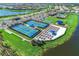 Aerial view of the community showcasing well-maintained tennis courts, a pool, and beautiful landscaping at 13805 Posada St, Venice, FL 34293
