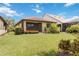 Backyard view of home with mature landscaping and screened lanai at 13805 Posada St, Venice, FL 34293
