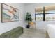 Bright bedroom with light grey floors, stylish artwork, and a peaceful view at 13805 Posada St, Venice, FL 34293