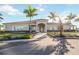Stunning clubhouse featuring a welcoming entrance, lush landscaping, and a well-maintained walkway at 13805 Posada St, Venice, FL 34293