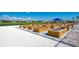 Community garden plot with raised beds, manicured grounds and blue sunshade at 13805 Posada St, Venice, FL 34293