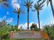 Elegant community sign for IslandWalk at the West Villages with lush landscaping and palm trees at 13805 Posada St, Venice, FL 34293