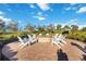 Outdoor fire pit with chairs, creating a cozy and inviting space for socializing and relaxation at 13805 Posada St, Venice, FL 34293
