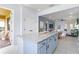 Open kitchen with island and stainless appliances offers views of the dining and living areas at 13805 Posada St, Venice, FL 34293