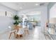 Eat-in kitchen area offering views of the chef's kitchen with blue island and white cabinetry at 13805 Posada St, Venice, FL 34293