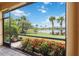 Screened lanai featuring brick floors and scenic pond views at 13805 Posada St, Venice, FL 34293