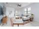 Bright living room with tile floors, a ceiling fan, and large windows for natural light at 13805 Posada St, Venice, FL 34293