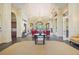 Welcoming lobby area with a sophisticated seating arrangement, fireplace, and plenty of natural light at 13805 Posada St, Venice, FL 34293
