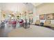 Elegant lobby featuring neutral color palette, large windows, and fireplace at 13805 Posada St, Venice, FL 34293