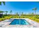 Private community splash pool with mature landscaping and clear blue sky at 13805 Posada St, Venice, FL 34293
