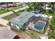 Aerial view of a home with a screened-in pool and fenced backyard at 1400 62Nd S Pl, St Petersburg, FL 33705