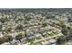 High-angle aerial shot showcases a sprawling neighborhood with mature trees and manicured lawns at 1400 62Nd S Pl, St Petersburg, FL 33705