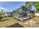 View of pool with screen enclosure in the backyard at 1400 62Nd S Pl, St Petersburg, FL 33705