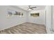 Cozy bedroom with wood-look floors and natural light from the windows at 1400 62Nd S Pl, St Petersburg, FL 33705