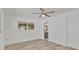 Bedroom featuring wood-look flooring, a ceiling fan, and an ensuite bathroom at 1400 62Nd S Pl, St Petersburg, FL 33705