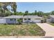 Charming single-story home featuring a well-manicured lawn and an attached garage at 1400 62Nd S Pl, St Petersburg, FL 33705
