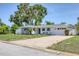 Charming single-story home featuring a well-manicured lawn, large driveway, and attached garage at 1400 62Nd S Pl, St Petersburg, FL 33705