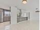 Open-concept kitchen with gray cabinets, stainless steel appliances, and pendant lighting at 1400 62Nd S Pl, St Petersburg, FL 33705