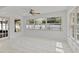 Sun-filled sunroom with tile flooring and large windows overlooking the lush backyard at 1400 62Nd S Pl, St Petersburg, FL 33705