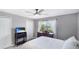 Inviting bedroom with a ceiling fan, dresser, and large window allowing for natural light at 1426 Harbour Blue St, Ruskin, FL 33570