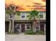 Townhome exterior showcasing tropical landscaping including palm trees at 1426 Harbour Blue St, Ruskin, FL 33570