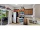 Well-equipped kitchen boasts stainless steel appliances, granite countertops, and access to the outdoor patio at 1426 Harbour Blue St, Ruskin, FL 33570