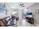 Comfortable living room with a television, wood laminate flooring, and staircase at 1426 Harbour Blue St, Ruskin, FL 33570