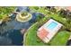Aerial view of community pool and beautiful pond with island in the middle at 1512 3Rd Street E Cir, Palmetto, FL 34221
