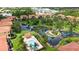 Aerial view of residential homes with a tranquil pond and community pool at 1512 3Rd Street E Cir, Palmetto, FL 34221