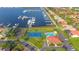 Aerial view of community with marina, tennis court, swimming pool, and clubhouse with ample parking at 1512 3Rd Street E Cir, Palmetto, FL 34221